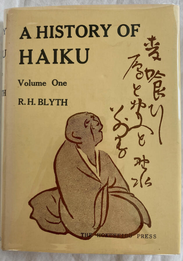Image of the cover of A History of Haiku: Volume One, by R.H. Blyth, showing a kneeling monk looking up at descending lines of Japanese characters.